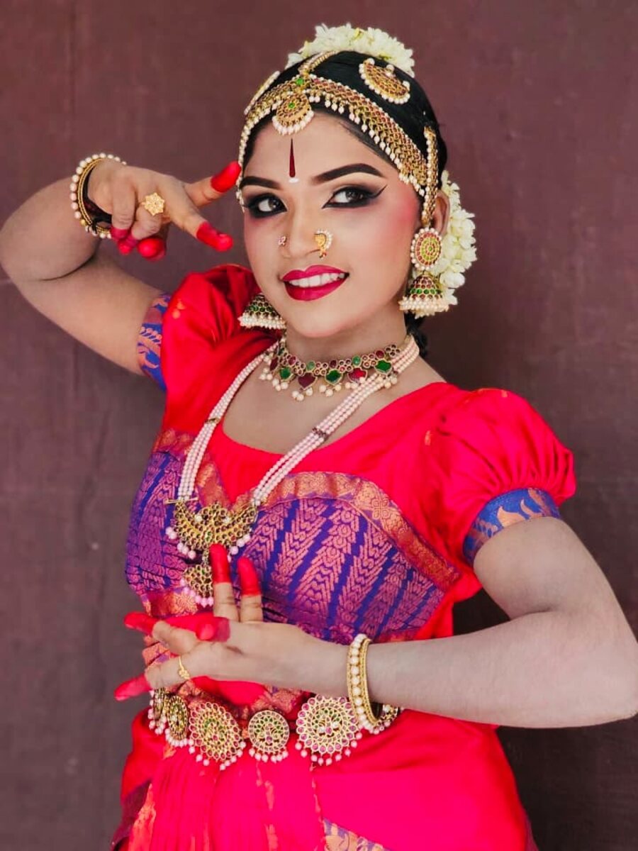 A Bharatanatyam dancer in a pink costume and temple jewellery, mid-abhinaya